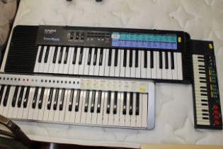 A Casio Tone Bank keyboard and two others