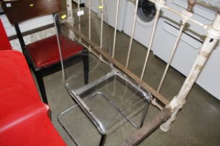 A metal framed Perspex chair