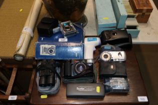 A collection of cameras and binoculars