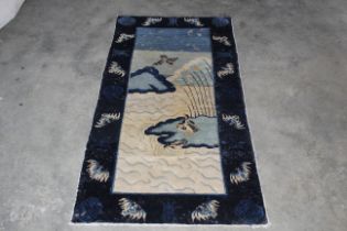 An approx. 5'3" x 2'10" wool rug decorated with ge