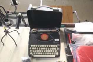 An Olympia Splendid 66 cased typewriter and packet of typewriting paper