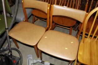 Two teak dining chairs