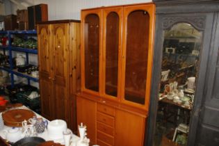 A modern display cabinet raised on cupboard base