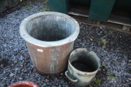 A large copper pot and a smaller twin handled stee