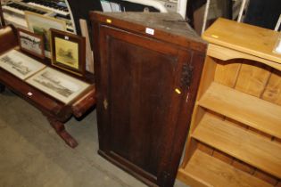 An antique oak hanging corner cupboard