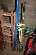 A quantity of garden tools including digging forks