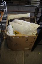 A box containing various pillows, cushions and duv