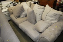 A button down upholstered settee