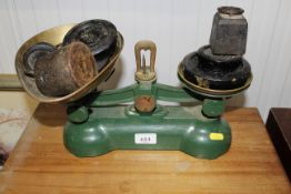 A set of kitchen scales and collection of weights