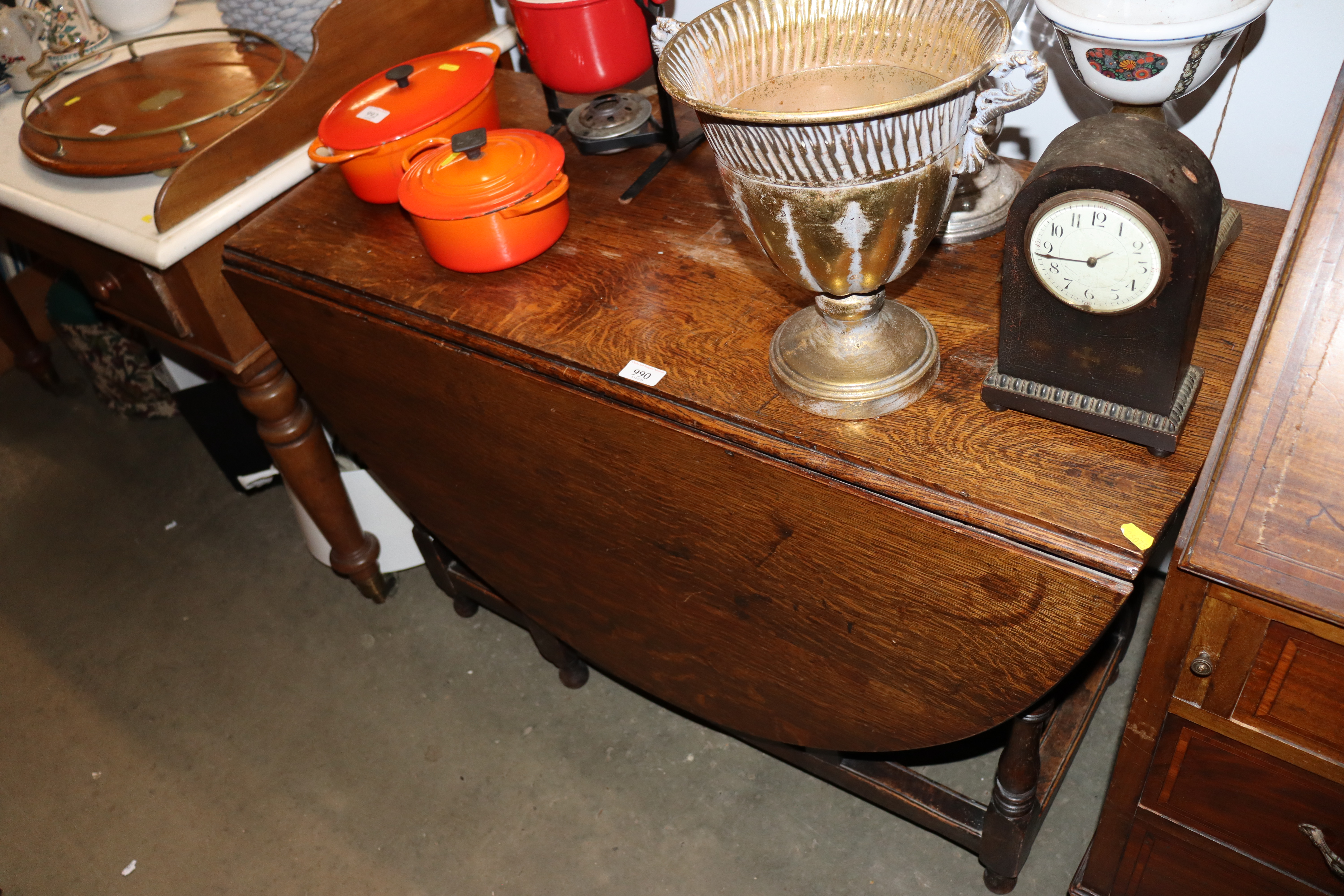 An antique oak gate leg dining table