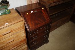 A reproduction mahogany bureau fitted four drawers