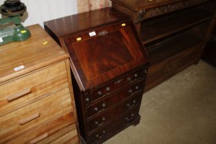 A reproduction mahogany bureau fitted four drawers