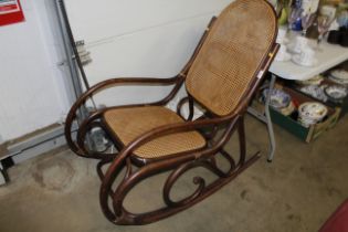 A bentwood and cane seated rocking chair