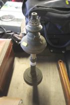 An oil lamp lacking glass shade