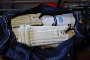 A cricket holdall and contents of cricket pads and