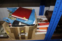 A box containing various stamps and albums