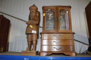 A jewellery display cabinet and a carved wooden fi