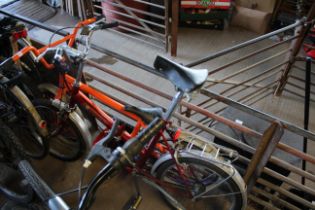 An Elswick Sovereign folding bicycle with front and rear mud guards, rear pannier rack