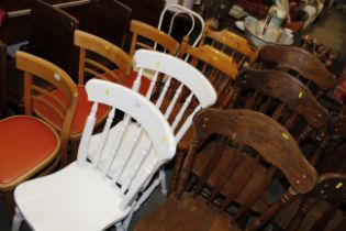 A pair of pine spindle back kitchen chairs; and a