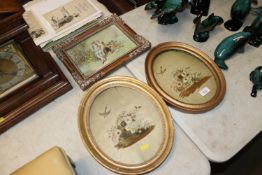 A pair of oval gilt framed needlework studies and