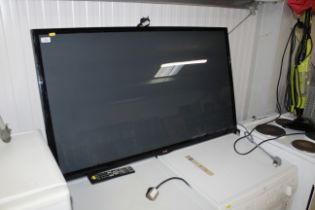 An LG flat screen television with remote control