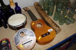 A ukulele; a rain stick; an African drum and a coc