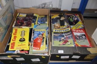 Two boxes of football programmes