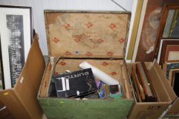 A wooden trunk and contents to include dolls; soft