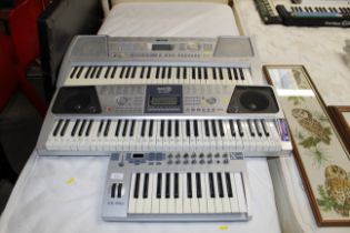 A Yamaha keyboard, a Rock Jam keyboard and an X-Bo