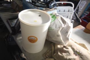 A plastic fermentation bucket and quantity of plas