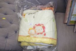 A child's cot buffer and blanket