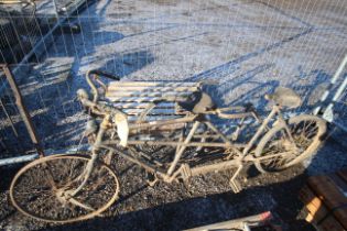 A tandem bicycle, together with a tandem frame and