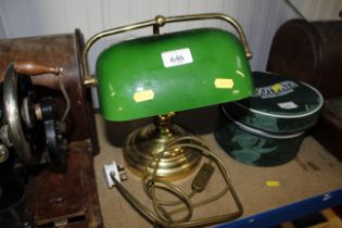 A brass desk lamp with green glass shade