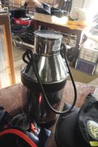 A stainless steel milk churn with swing handle (64