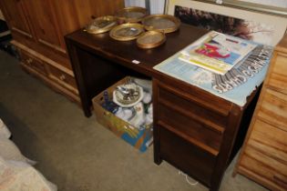 A modern single pedestal desk fitted three drawers