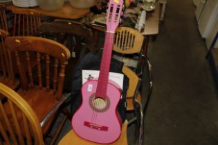 A child's acoustic guitar and carry bag