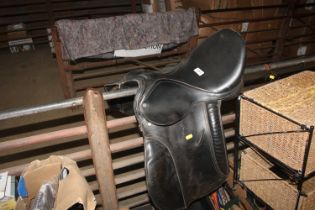 A tan leather draft horse showing bridle with leader, leather rosettes and twisted straight bar