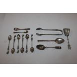 A set of six white metal spoons with cherub decora