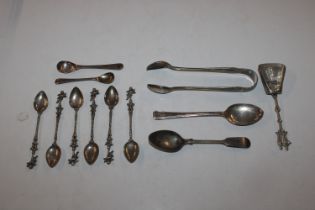 A set of six white metal spoons with cherub decora