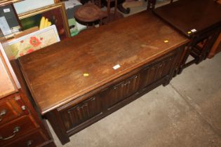 An oak and linen fold decorated blanket box