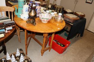 A pine gate leg drop leaf table together with thre