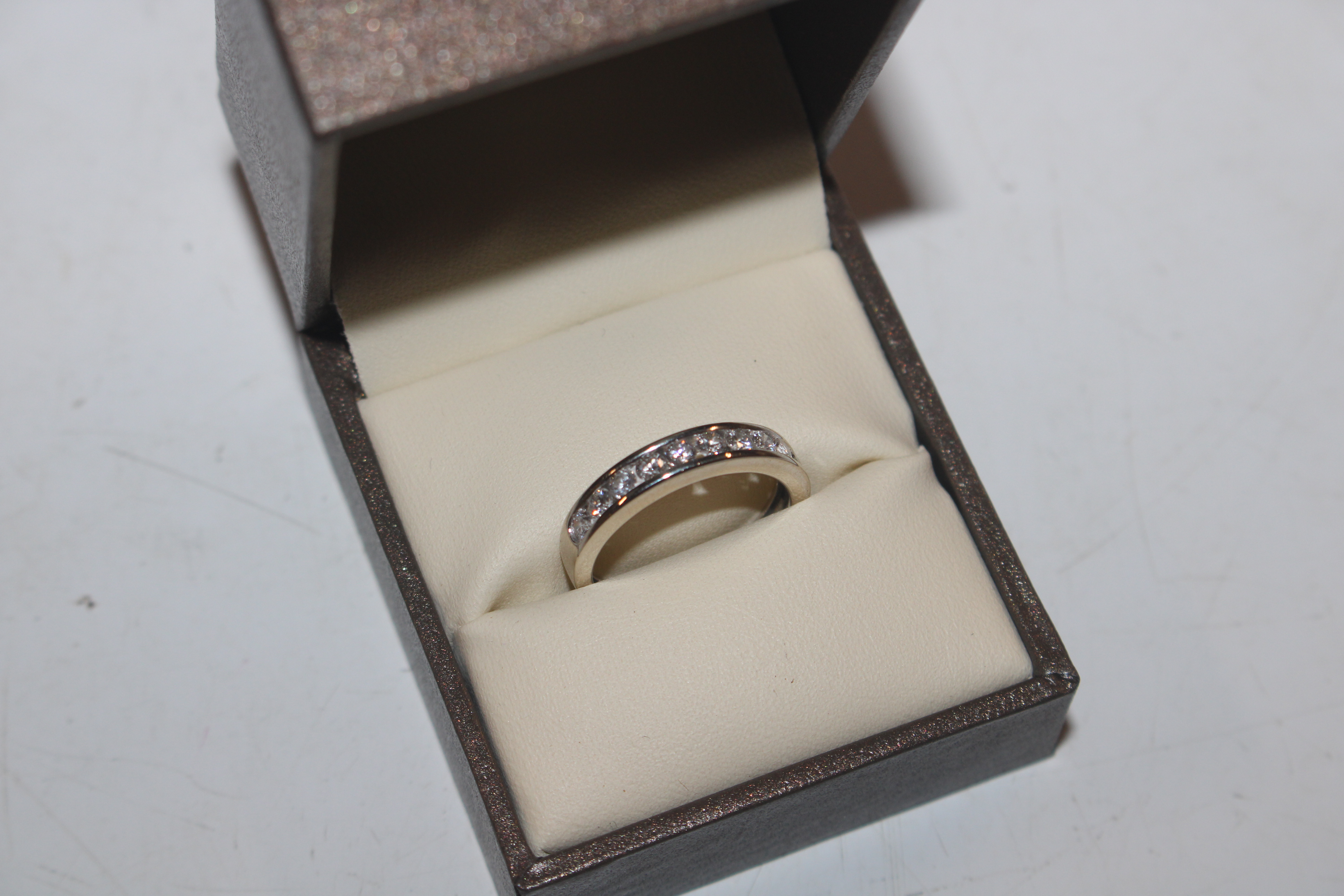 An 18ct white gold (marked rubbed) half eternity ring set with channel of ten diamonds totalling - Image 2 of 10