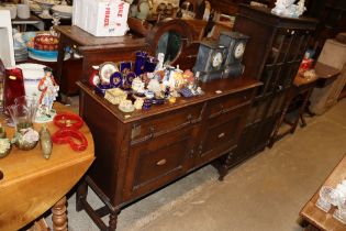 An oak mirrored back sideboard fitted two drawers