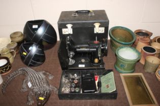 A Singer sewing machine No. 221K with instructions