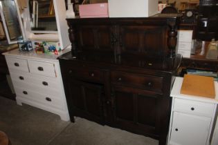 An oak court cupboard fitted two drawers and raise