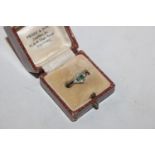 An 18ct gold Art Deco style ring set with green an