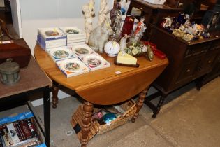 A cherrywood drop leaf dining table