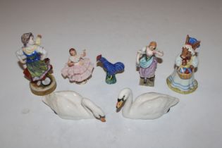 Two Beswick model swans; a pottery model of a cock