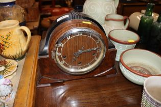 An Art Deco three hole mantel clock