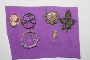 A collection of Sterling silver brooches including